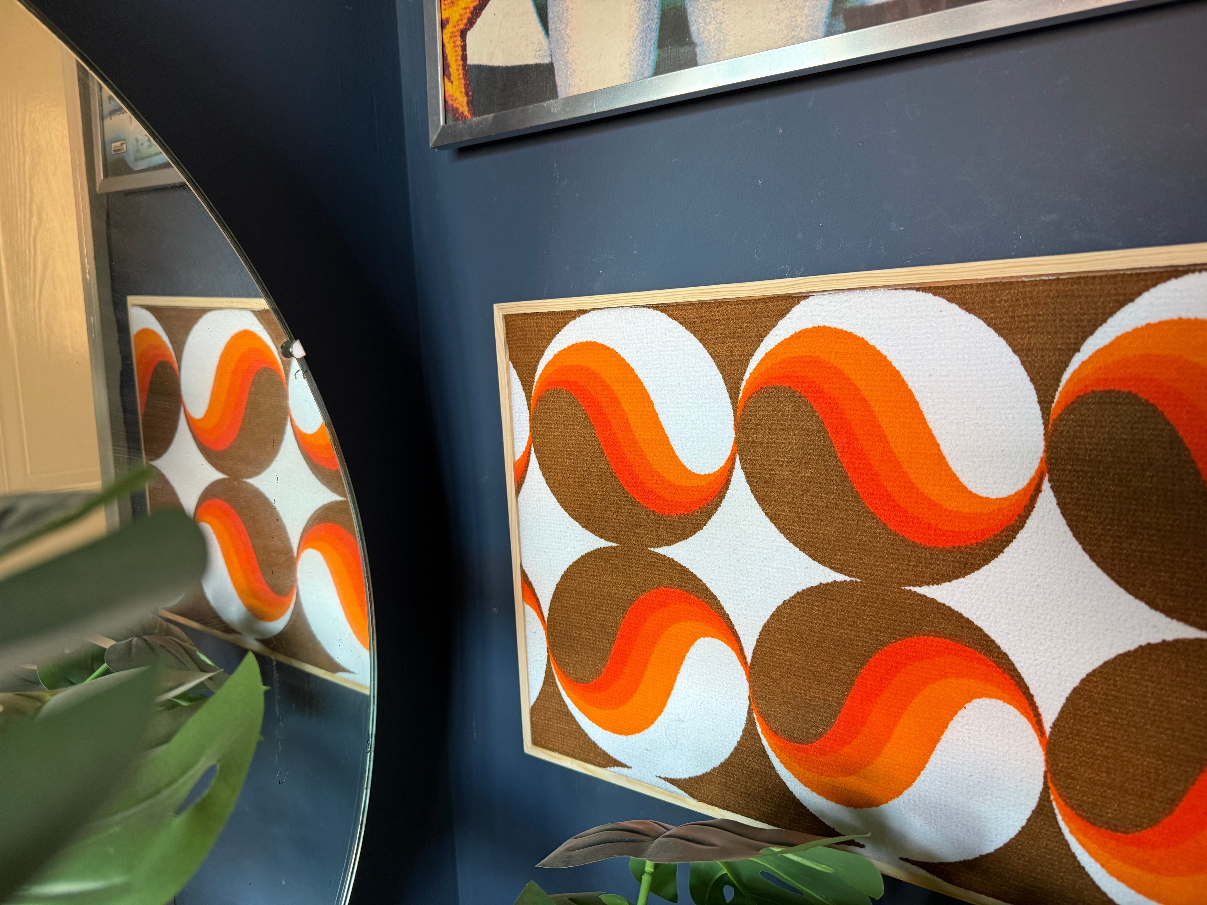 Framed vintage fabric art with retro orange and brown wave pattern